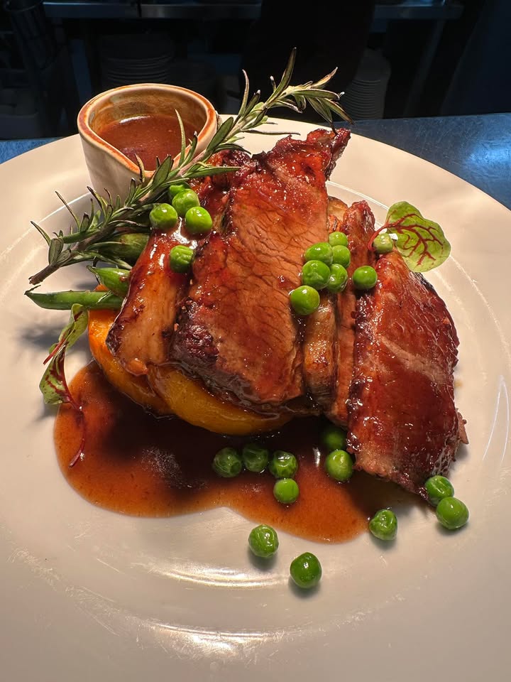 Featured image for “Sunday Special: Slow-roasted beef served with golden roast potatoes, fresh garden peas, and a rich rosemary-infused gravy-crafted to bring comfort and flavour to your weekend. #thelodgekitchen #AsquithBowlingClub #wp”